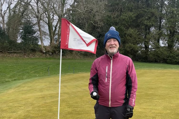 John Raphael stands proudly alongside hole 5 after his hole in one.