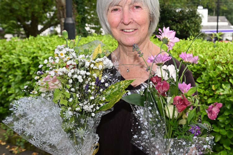 Pat with some of the many flowers on offer made by the patients and staff of Stratton Hospital
