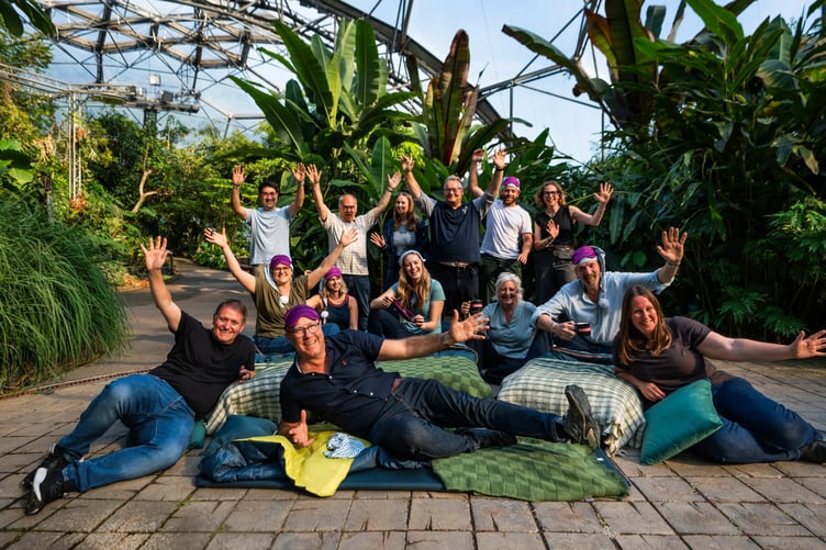Cross party MPs, Eden and Parliamentary Knowledge Foundation staff get ready for a night camping in the Rainforest Biome, cheering. Andy Jasper Eden CEO is pictured up front.