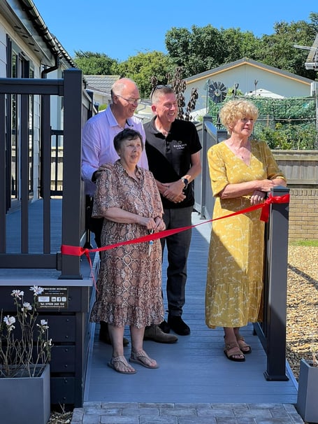 Members of Meadowlands Court Residents' Association cutting the ribbon on the new communal lounge at Meadowlands Court in Bude