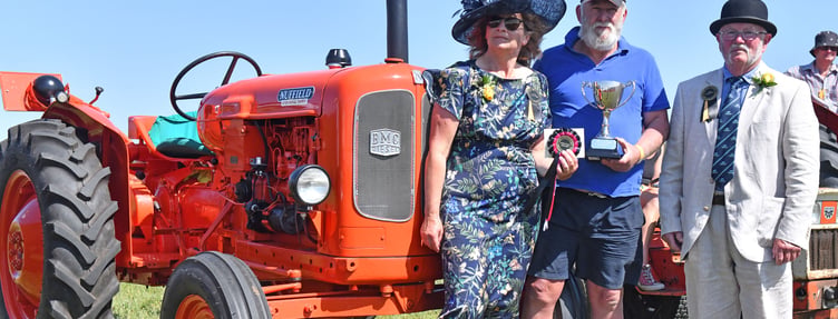 Vice Presidents of the show Juliet and Chris Cleave present the Bert Scawn Memorial Cup to Steve Medland of Canworthy Water for best tractor in the Show a 1957-58 Nuffield Universal 3 (Picture: Adrian Jasper)