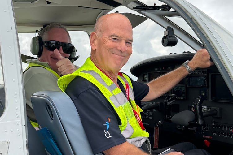 Michael gives a thumbs up to signify he is ready for this next adventure in a light aircraft