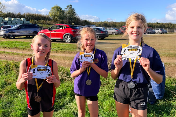 The Year 5/6 Girls top three are all smiles after smashing their opening race at Great Trethew