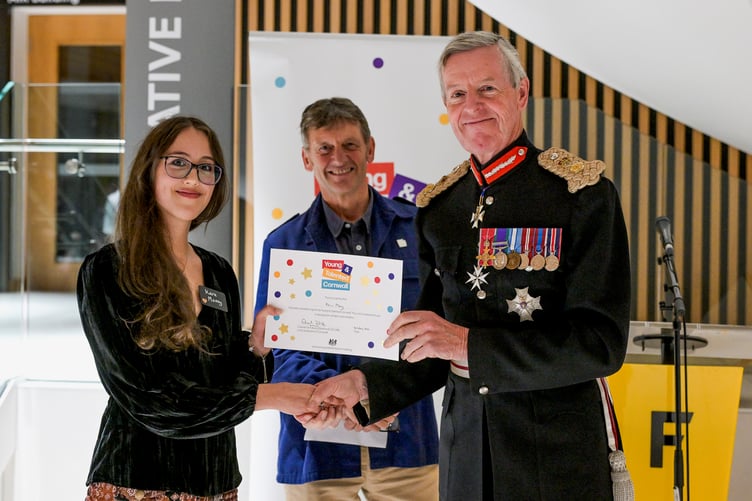 Keira Money, a 19-year-old from Redruth who is currently working on a young adult crime and mystery novel inspired by her childhood in Cornwall, is pictured with Philip Marsden and the Lord Lieutenant